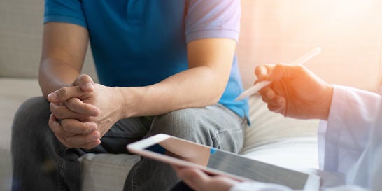 Cropped visual of man talking with doctor